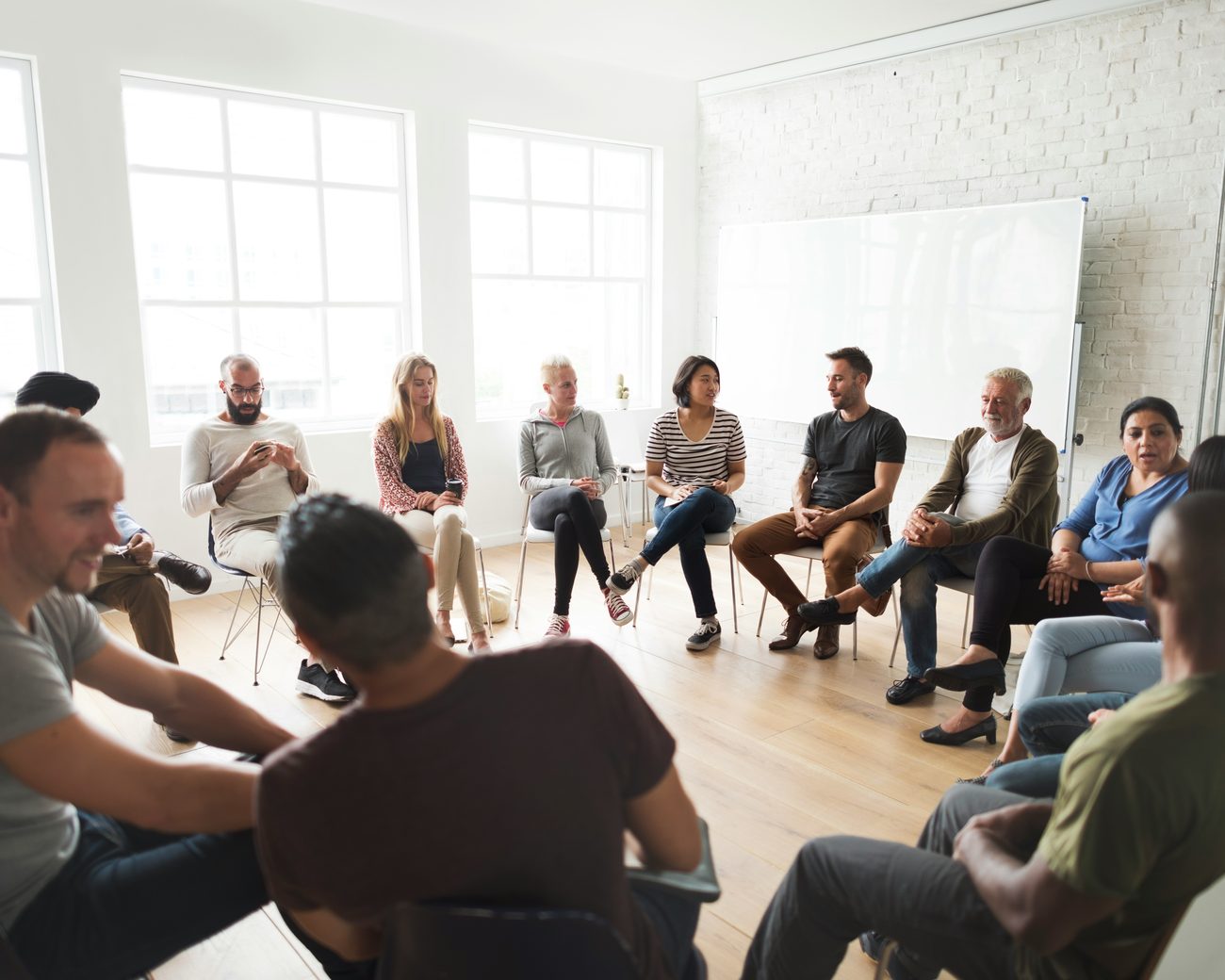 People taking part in a welcoming SMART Recovery meeting