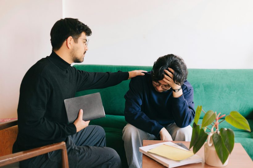 A facilitator supporting someone one to one